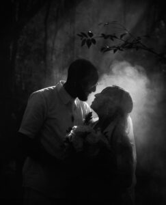 Intentional blur photo dark and moody silhouette of bride and groom in smoke